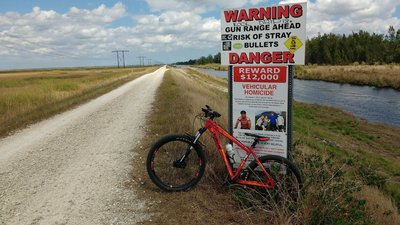 Sign warning of possible stray bullets from nearby target range at Markham Park.