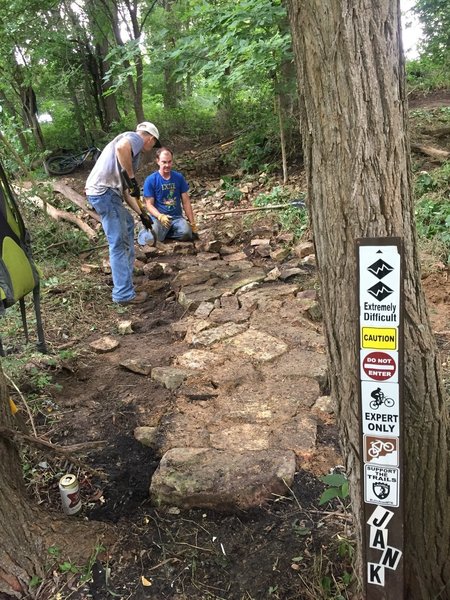 Local builders installing rock "garden" at the bottom of JANK.