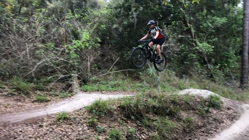 My son getting some air in the first few jumps of the trail.