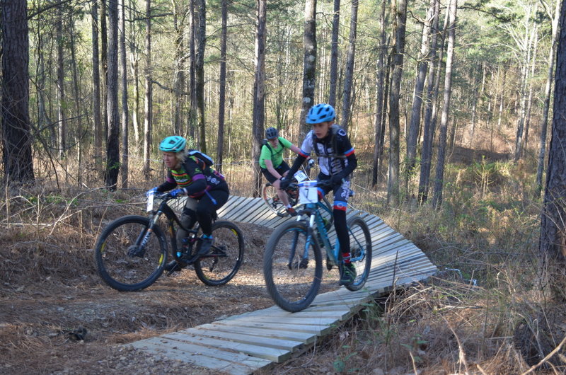 racers sharing the trail, at the Sandy Hill Berm during the NOMAMBO's Run to the Hills race at Mount Zion