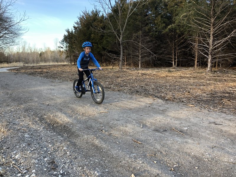 This section of the trail transitions from crushed rock to concrete.