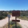 This sign is at the start of the parking lot. Ride the trail in a clockwise loop for fun downhills coming back.