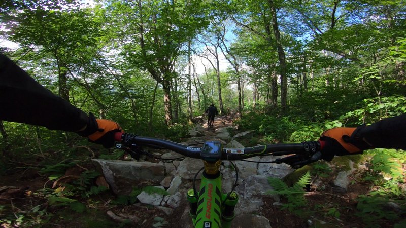 Following Jalen through one of the many rock gardens on Super Natural at Sugar Mountain Bike Park.