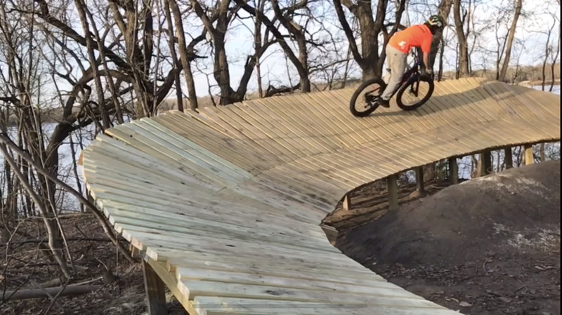 This is the key feature in the trail section "Huck Harbor." It's a large, dual-angle wood berm that is about 70 feet long and transitions to a smooth 3 to 4-foot drop. Time to huck it!