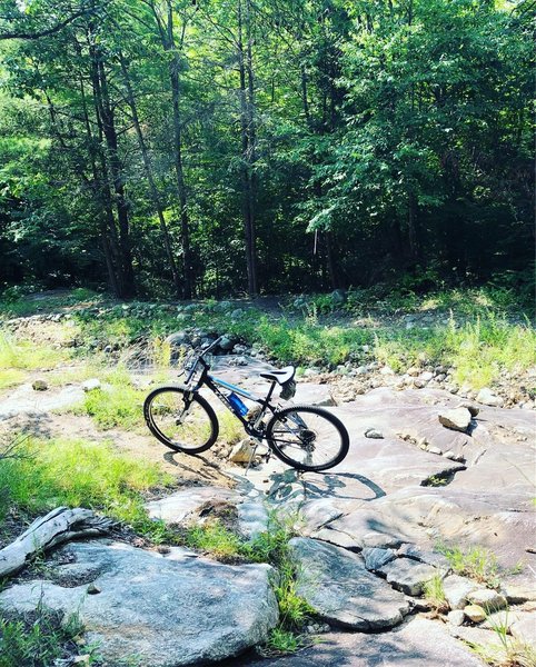 Halfway up and crossing over the rock face .