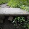 This wooden drop is at the intersection of Iron Gate trail (shown exiting to the left before drop) and Concrete Block. Totally worth a session before you go back up to continue down Iron Gate.