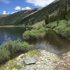 The road around Mirror Lake is submerged, requiring a hike-a-bike through dense brush.