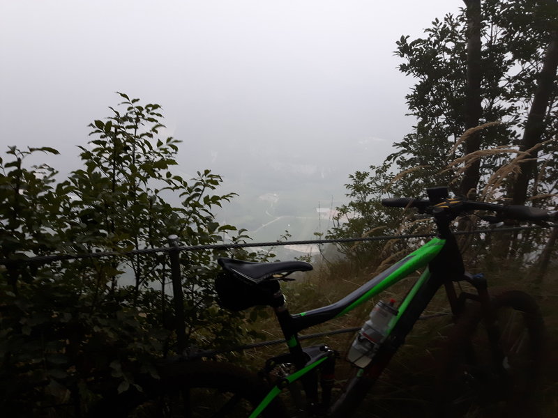 In the dust of the morning: high above the town of Nago. The trail is leading just beside the rim here.