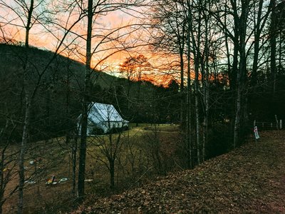Sunset view of mountains, trees and church near lower trailhead and parking spot
