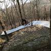 Elevated ladder bridge over some huge boulders