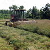 Farmer mowing hay in Genesee River Valley near Angelica, NY