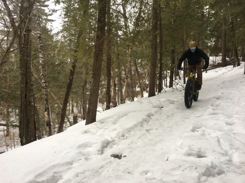 Winter ride with cliff band along creek in background.