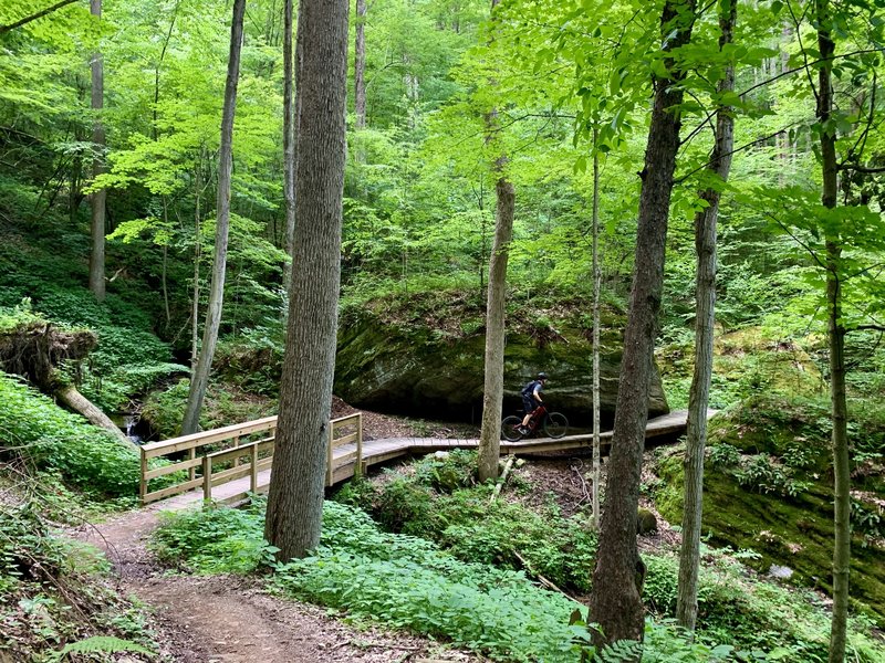 A cool bridge that winds around and over boulders.