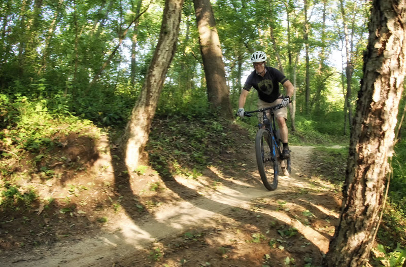 Rider enjoying some pumpy bench cut trail at Creekside.