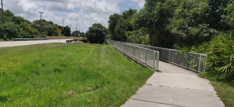 The trail system starts under the bridge. There was no signage when I was there, it took a while to find the entrance.