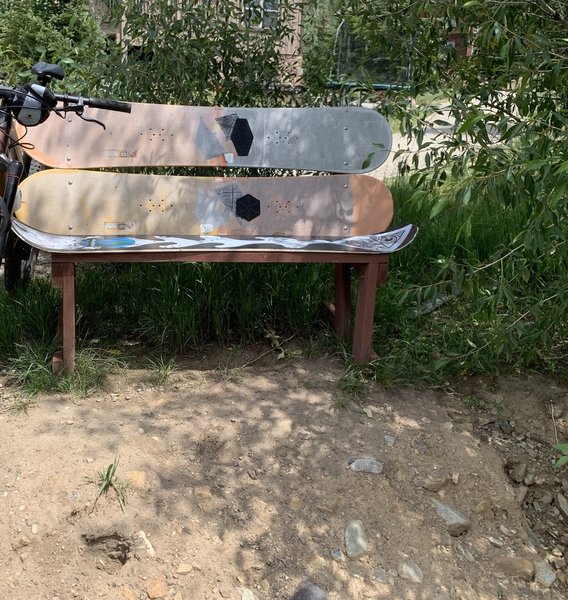 Surfboard bench right off creek.