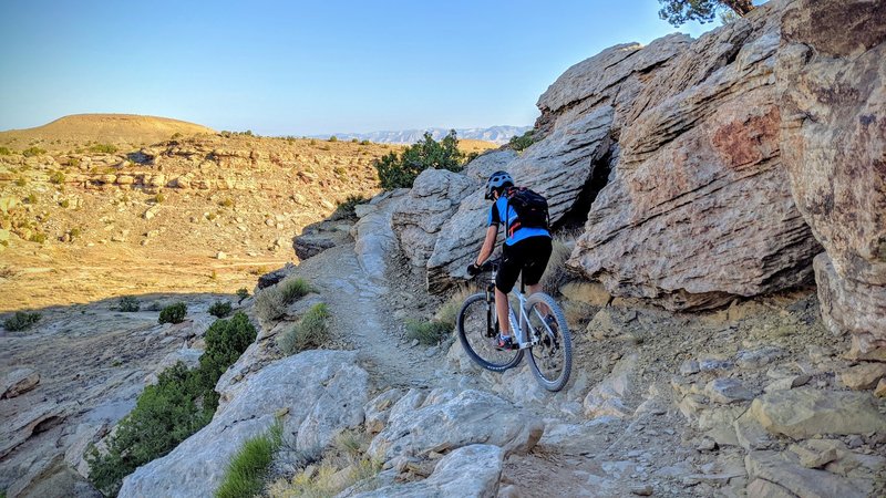 My son navigating a rock section. The picture is a bit misleading, the drop on the left is at least 20'.