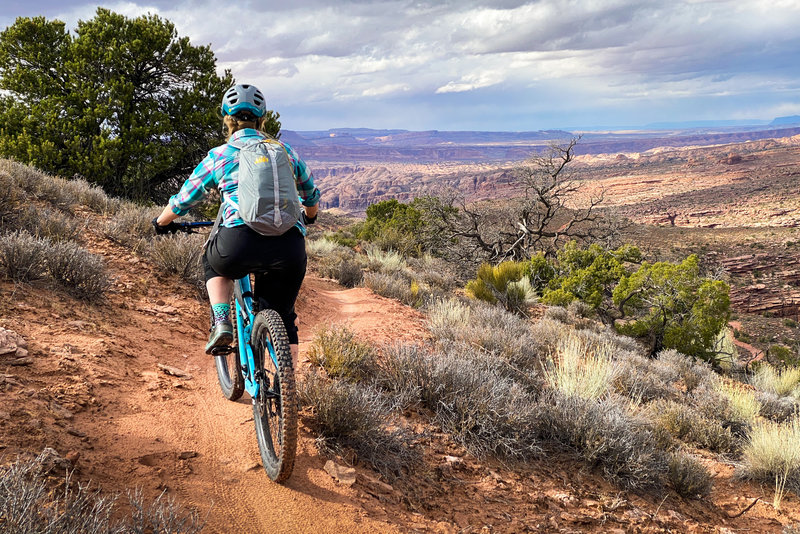 Ashley pedals along Falcon Flow in Moab, UT.