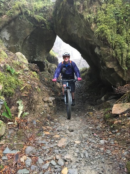 Riding through a natural rock arch