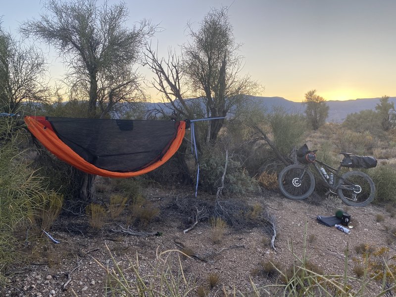 Bike packing in a hammock with a view of city lights