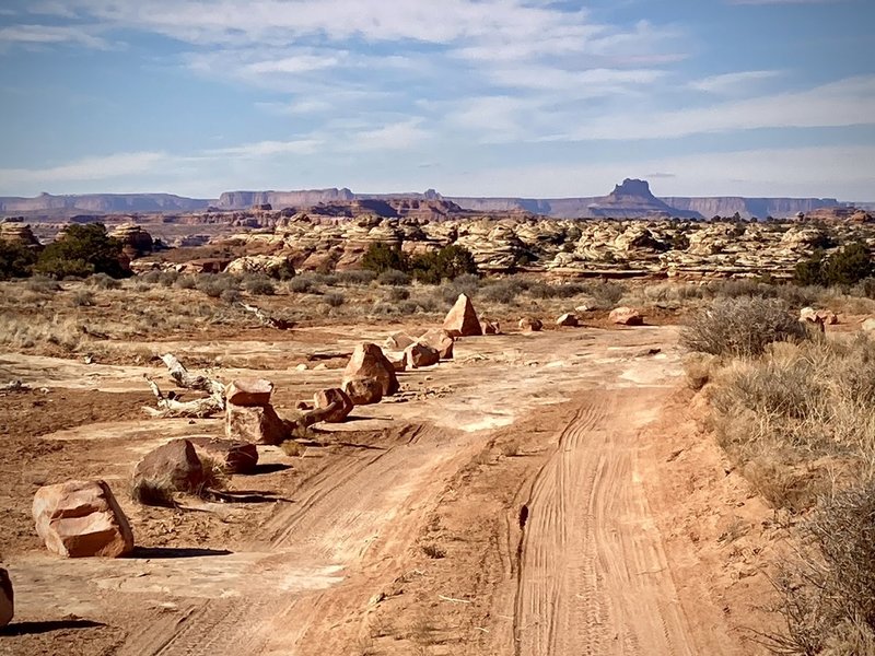 Typical riding conditions on the CO Overlook Trail. Maze District, Ekker Butte and Cleopatra's Chair in distance.