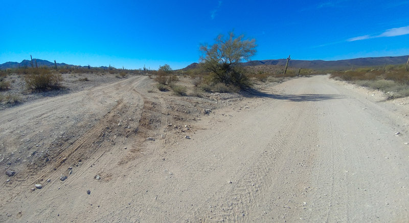 Eastern terminus of the F-Road Cutoff (left), looking west from the main road (Rasmussen Road Extended, right).