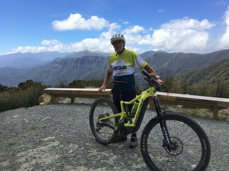 The track traverses the escarpment behind the rider's right shoulder as seen from Moonlight Hut.