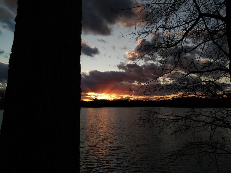 View of the sunset across the lake while on the East Trail.