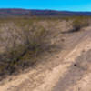 Looking east down Saikil (8106A) at the trail marker for 8106D that heads north. Composite of 2 images (slightly distorted).