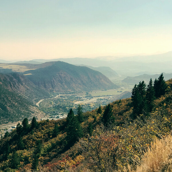 Looking towards the city of Glenwood while the valley opens up in the background hiding Aspen behind fog and mountain faces