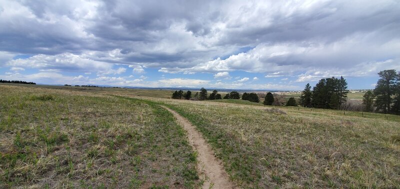 Trail with peaks in the distance.