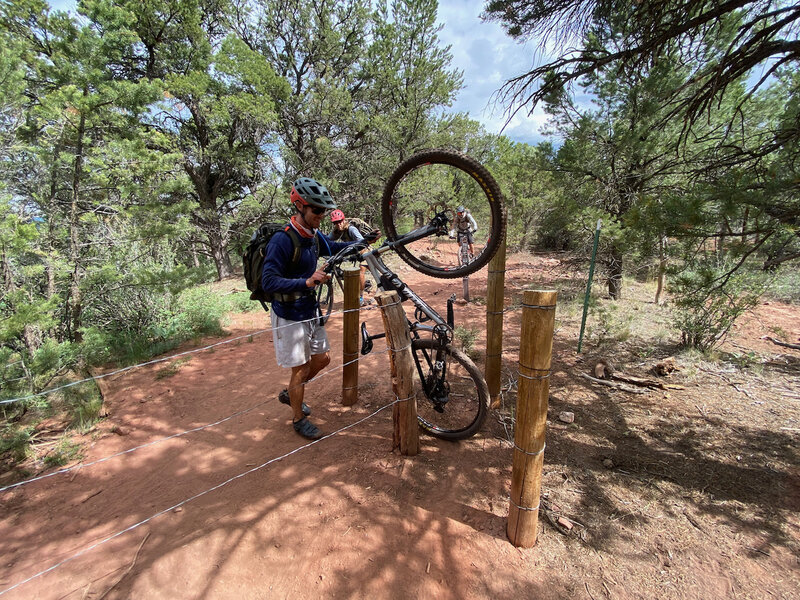 Maneuvering a bike through the recently improved chicane structure at the Lorax fence line.