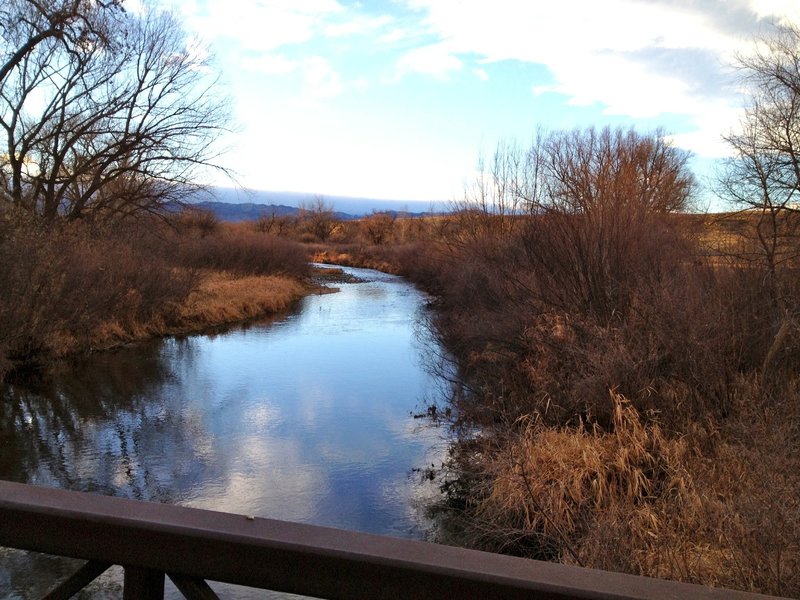 Peaceful resting spot on the wooden bridge across Boulder Creek.