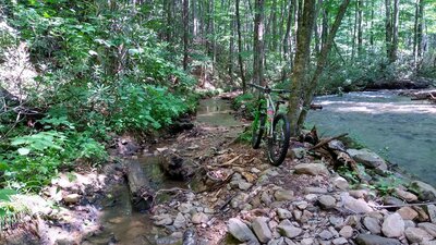 A section of Comers Creek trail has been reclaimed by the river.