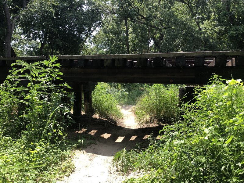 Trail passes under active rail road trestle. You have to duck to get under it.