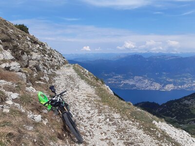 The old military trail to Bocchetta del Coal Santo: view down to Lago di Garda and the Adamello-Mountains in the back