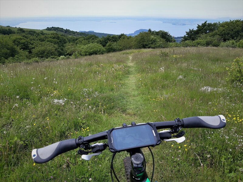 Sentiero #51 at the meadows of Malga Zocchi (elev. 1.260m) above Lago di Garda and peninsula of Sirmeone (back)