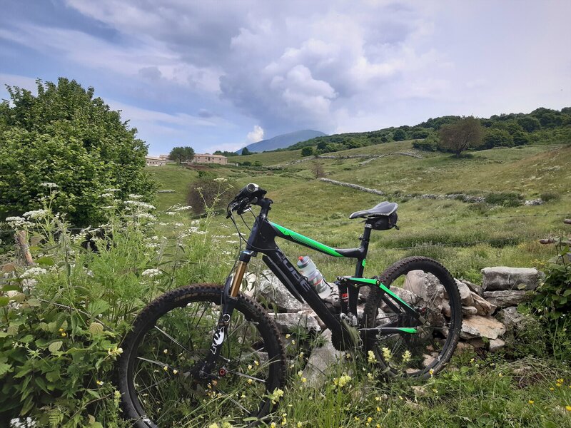 Beside Sentiero #5: View to Monte Baldo (Cima Costabella) and to the buildings of Malga Montesel