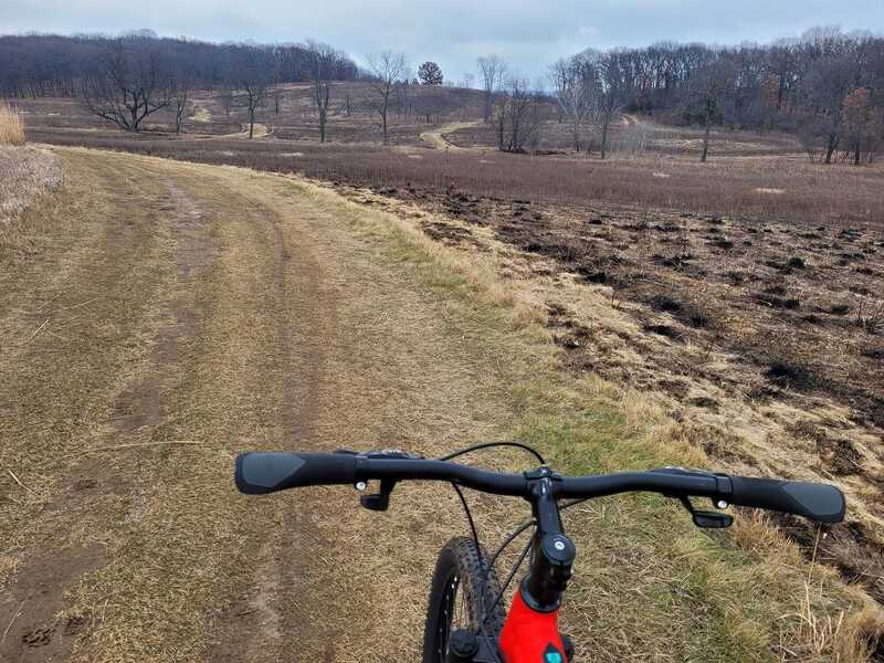 Approaching a hill through the prairies. Notice the aftermath of a prescribed burn!