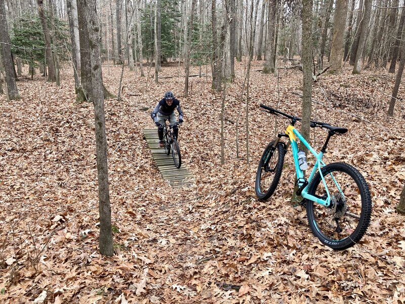 Crossing the unnecessarily placed "bridge." Yet another uneventful, not technical, trail at Hardwood Mills. This biker is my 65-year-old dad, who also found this trail rather mundane.