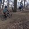 An adaptive mountain bike rider enjoying the air with his follower on Space Jam.