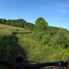 A segment of this trail is on the edge of an open field.