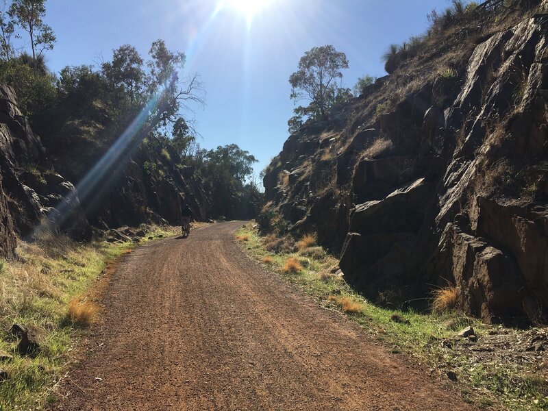 Rail trail cut through rock face.