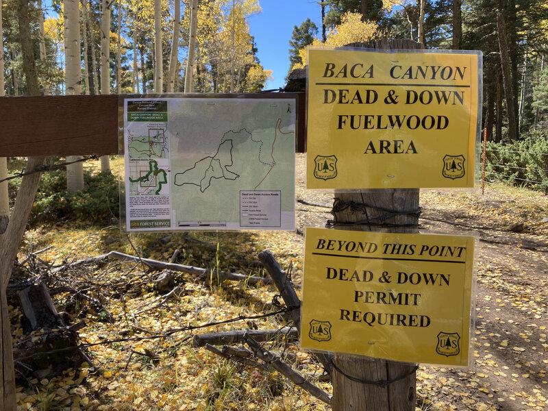 Signs at the entrance to the fuelwood area include a map detailing roads continuing to Baca Canyon