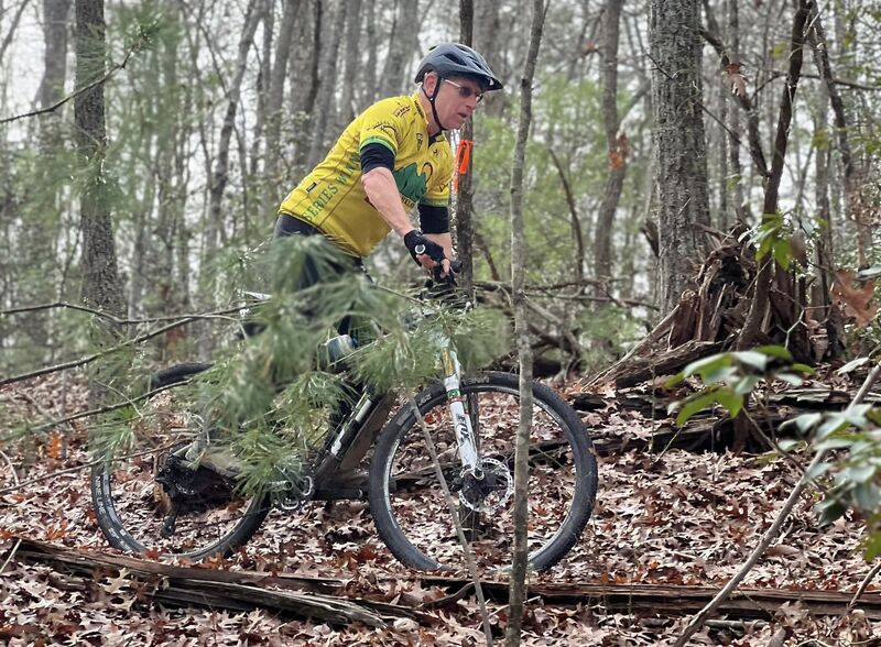 The builder of the trail at the top of the technical switchback descent.