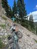 Washed out scree field at 11k feet. 15-20 feet of wash out. Took 3 people to pass bikes over.