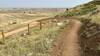 A turn of the trail with views over the plains in the background.