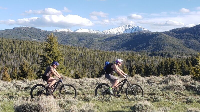 Two mountain bike riders on Roosevelt Loop Trail with Red Mountain in the background.