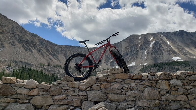 Fatbike on top of the stone walls of Hearst Lake with Mt Haggin in the background.