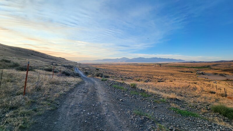 BLM #1 Trail follows a fenceline with the Tobacco Root Mountains as a backdrop.